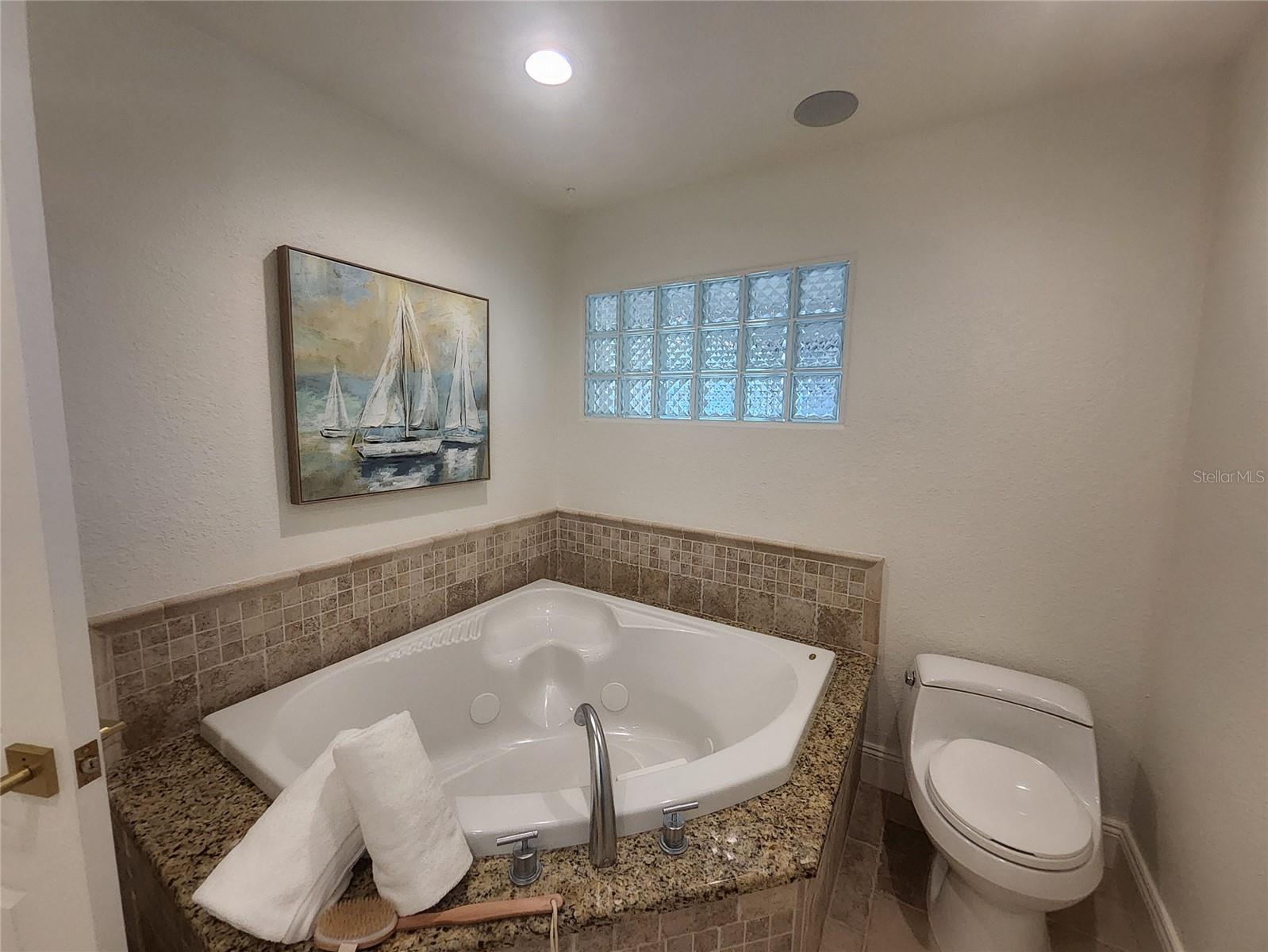 Primary bath has Jacuzzi soaking tub