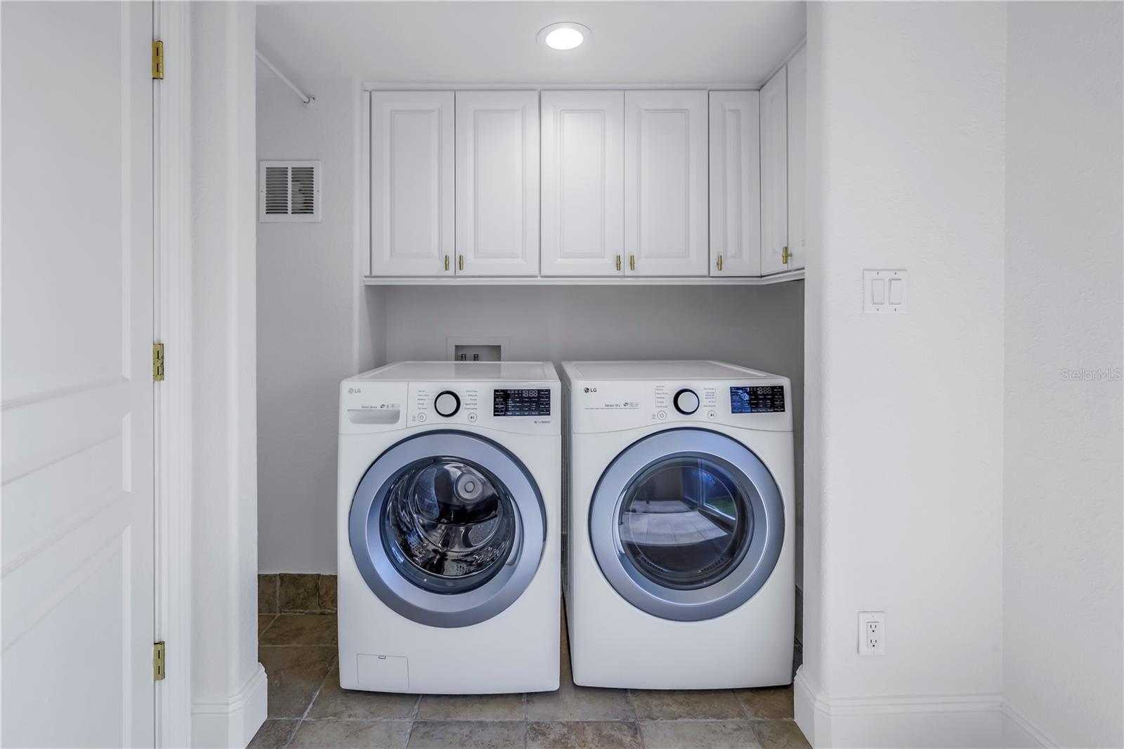 Full size washer and dryer and storage in laundry room