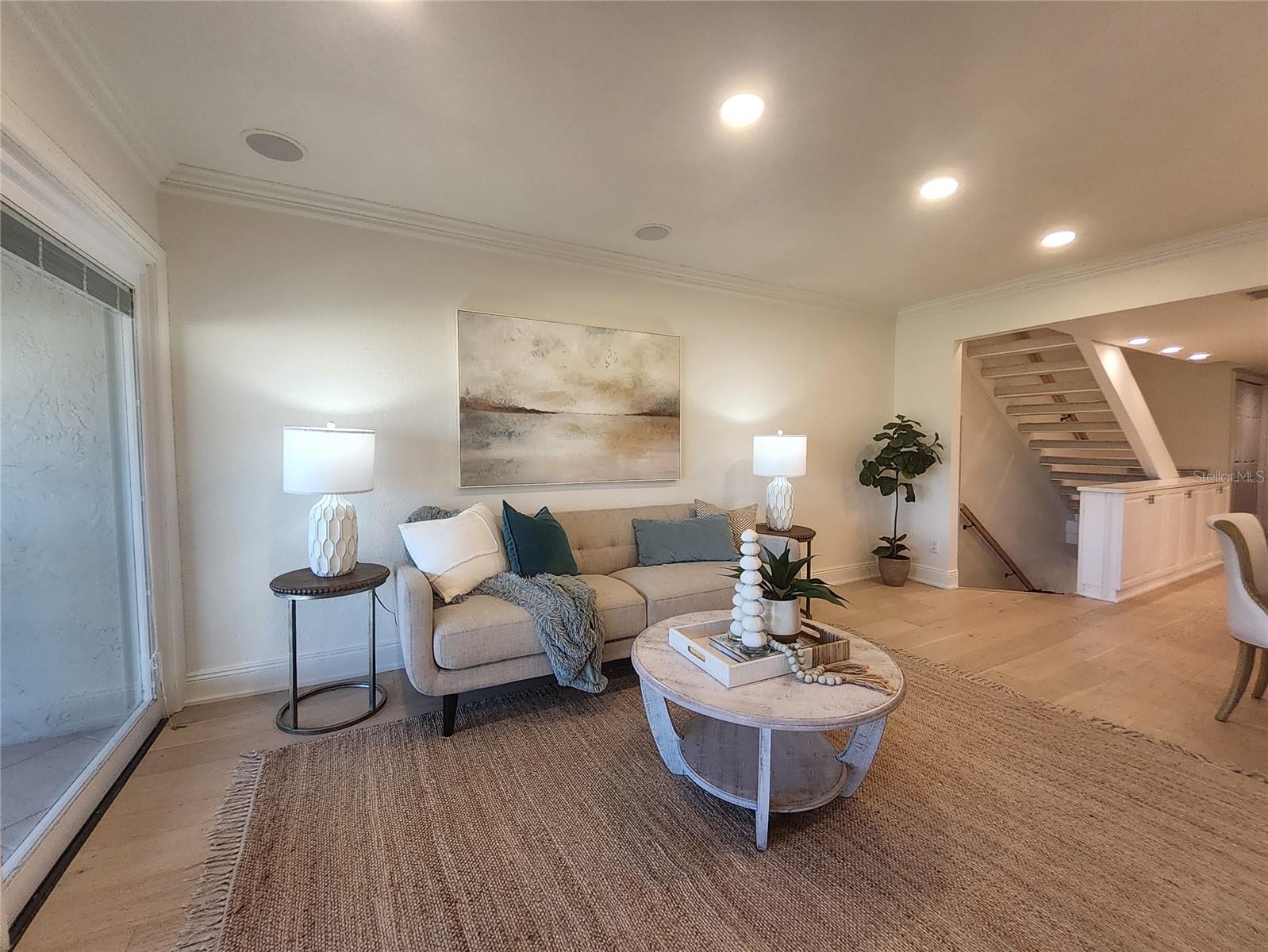 Living Room with crown molding and recessed lighting