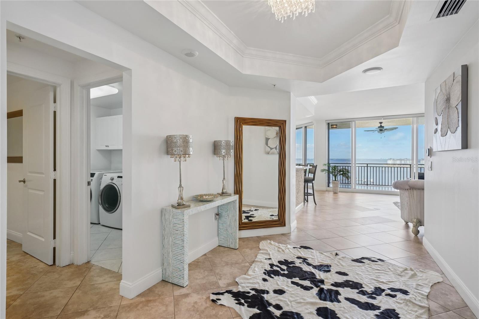 Open-concept living with floor-to-ceiling glass and sweeping bay vistas