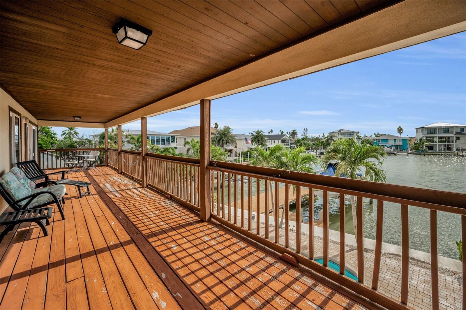 Second floor balcony overlooking the pool and water.