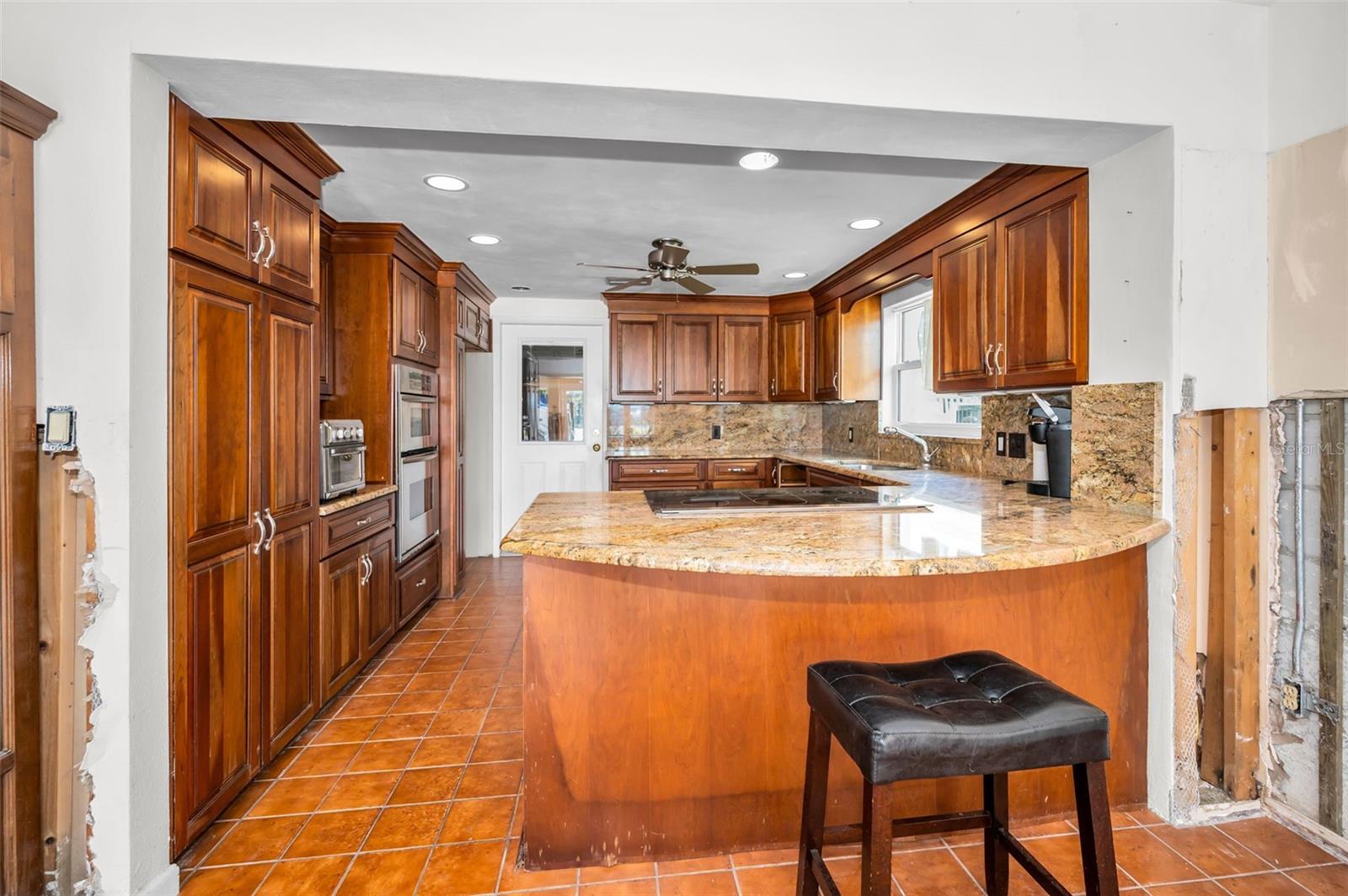 Spacious kitchen with eat-in bar.