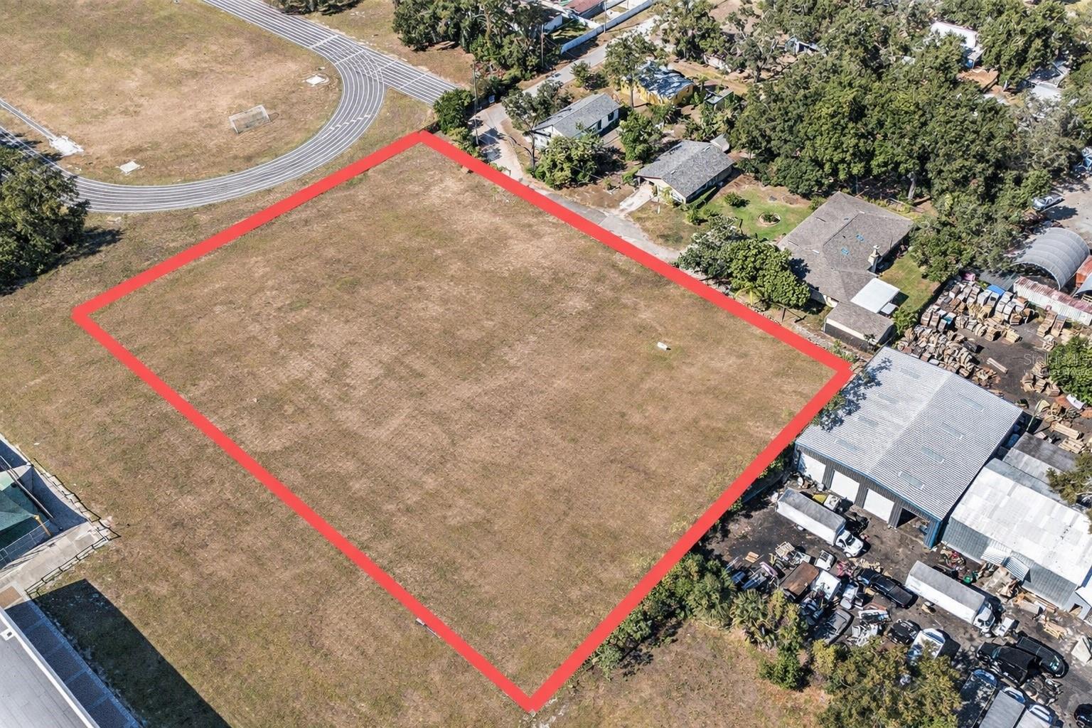 Virtually staged to remove the trees to show vacant land potential.