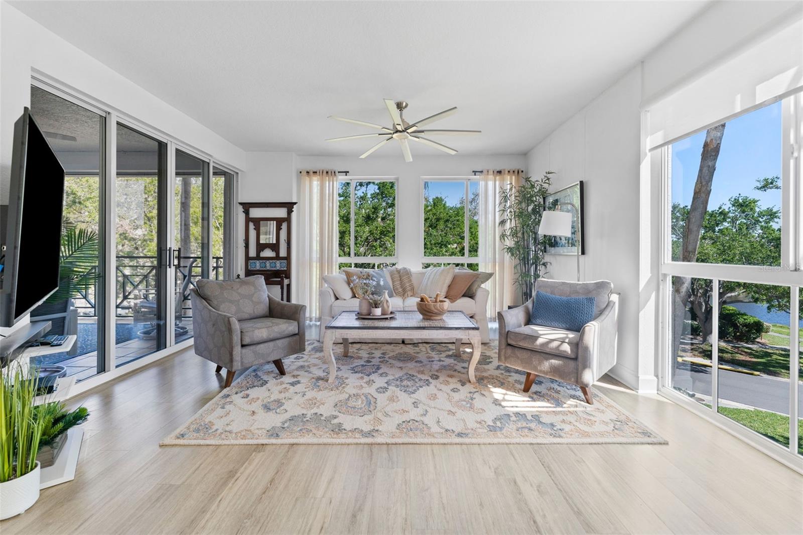 Bright and cheery Living room, with oversized balcony access.  Not Floor to ceiling windows in this end unit.