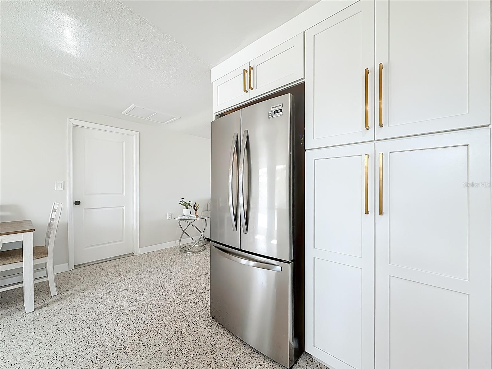 Kitchen pantry with stainless refrigerator