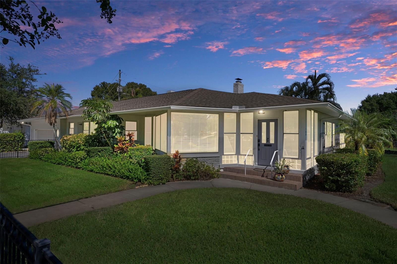 The home illuminated beautifully at twilight.