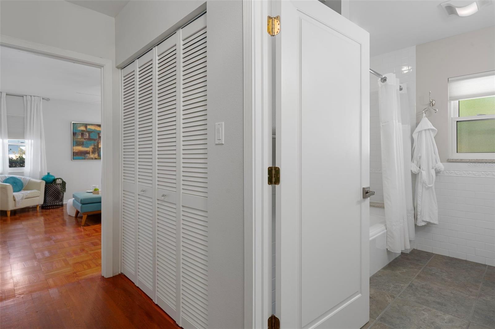 To the right is the second bathroom, with the laundry closet beside it and the second bedroom straight ahead.