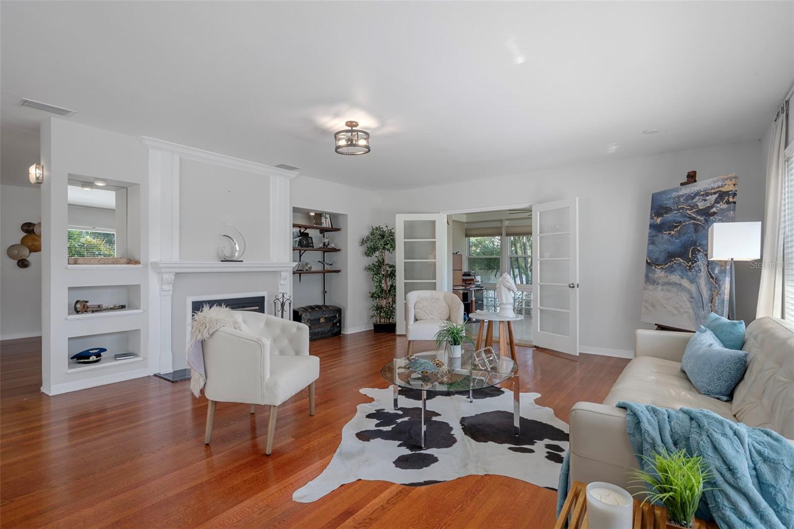 Spacious living room with fireplace and beautiful hardwood floors.