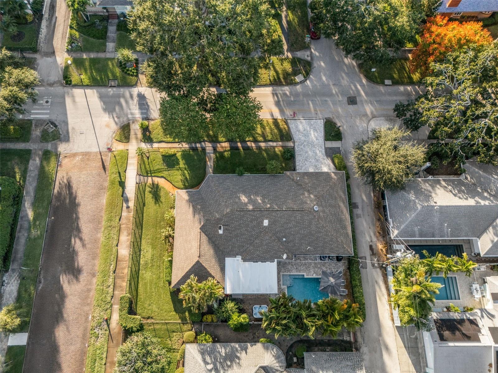 Large corner lot. Fully fenced yard perfect for pets or play, surrounded by low-maintenance landscaping. Pool and paved deck in the back.