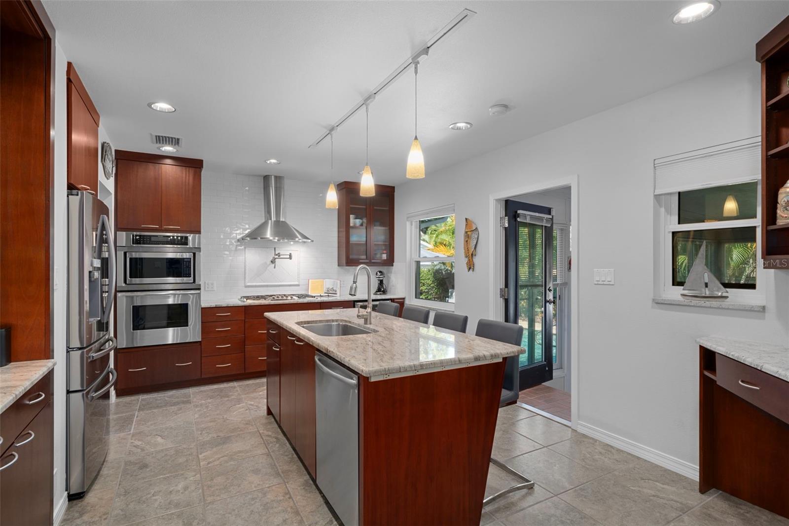 The remodeled kitchen features custom solid wood cabinets and stainless appliances.