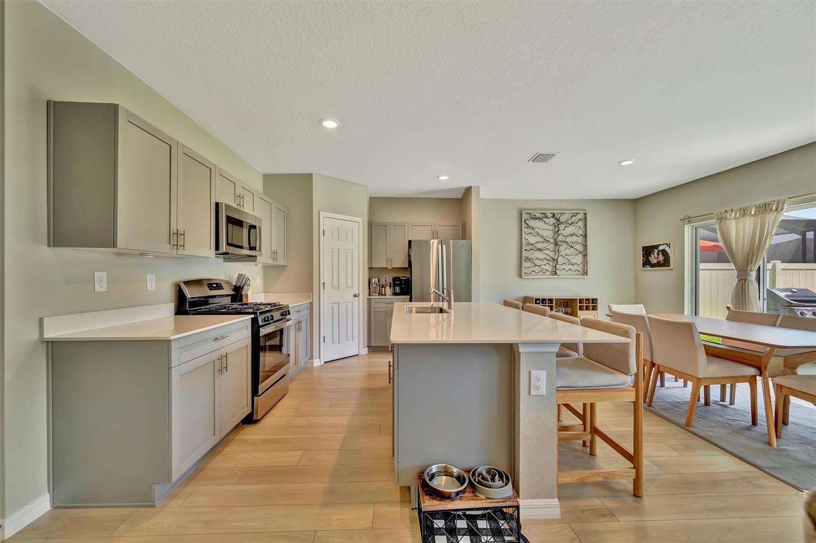 Open layout kitchen with island and stainless steel appliances
