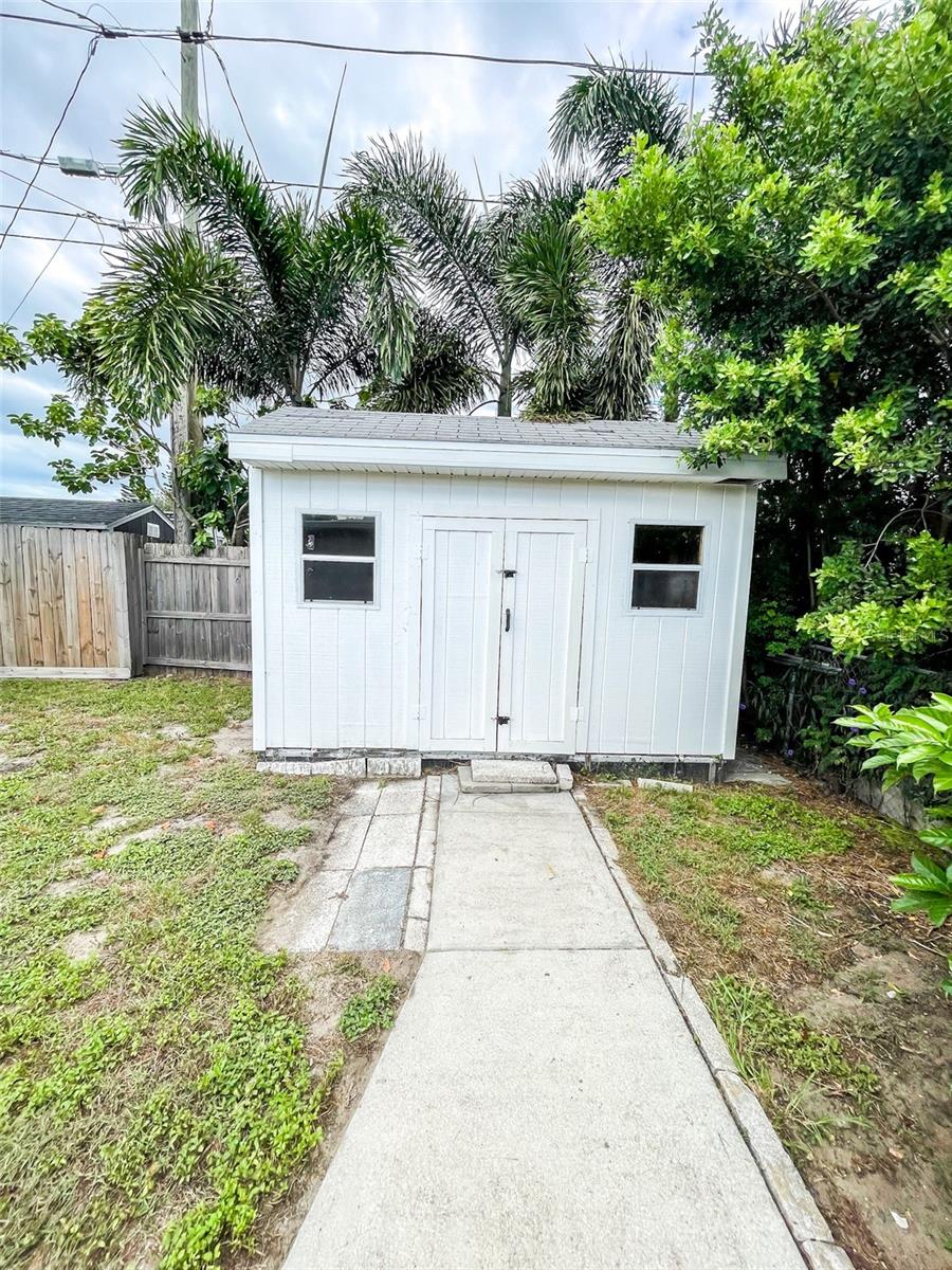 Walk in shed for outdoor storage.