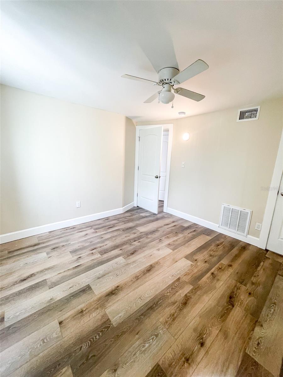Bedroom 1 is adjacent to the family room and across the hall from the bathroom.