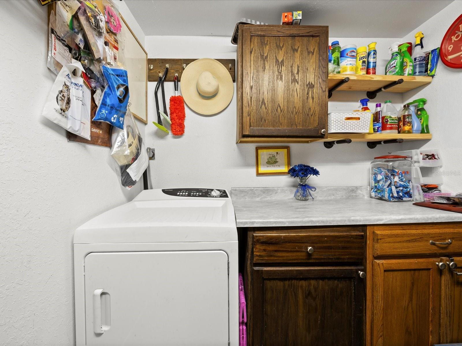 Laundry room with storage located in the master suite
