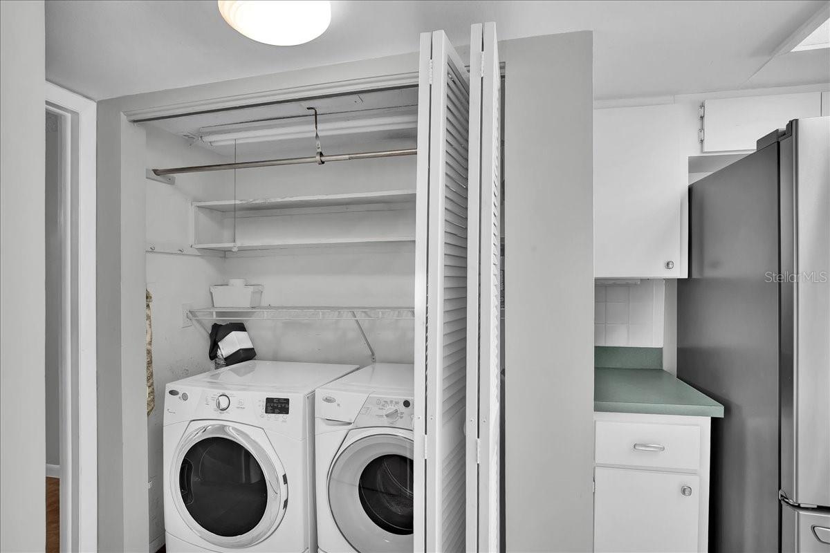 Laundry closet with lots of shelving