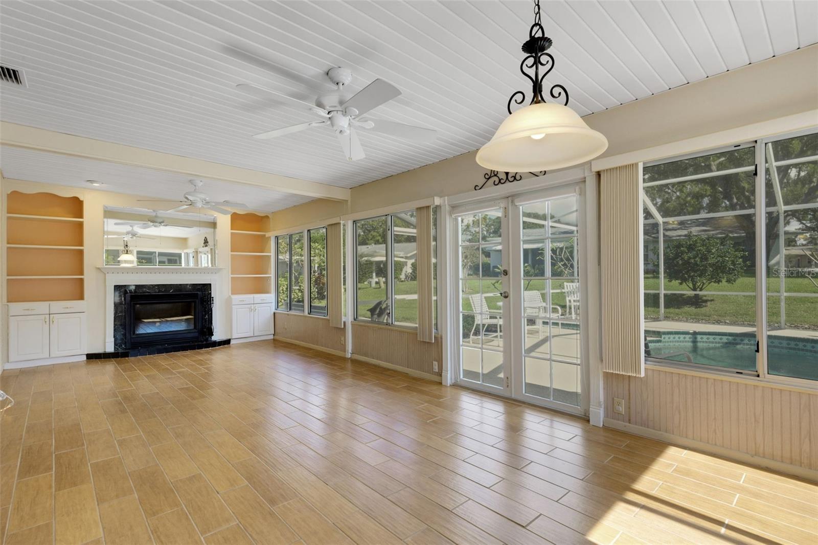 Family room open to birdcage pool