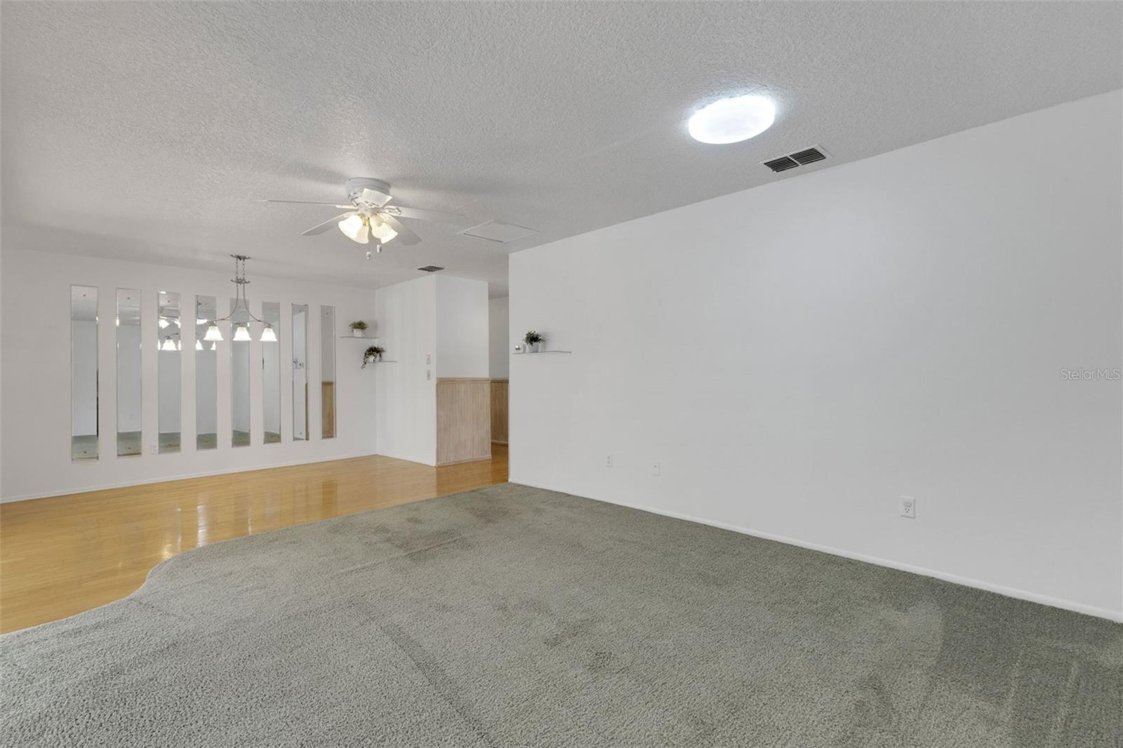 Sellers had dining table under the 3 lights on hardwood floors