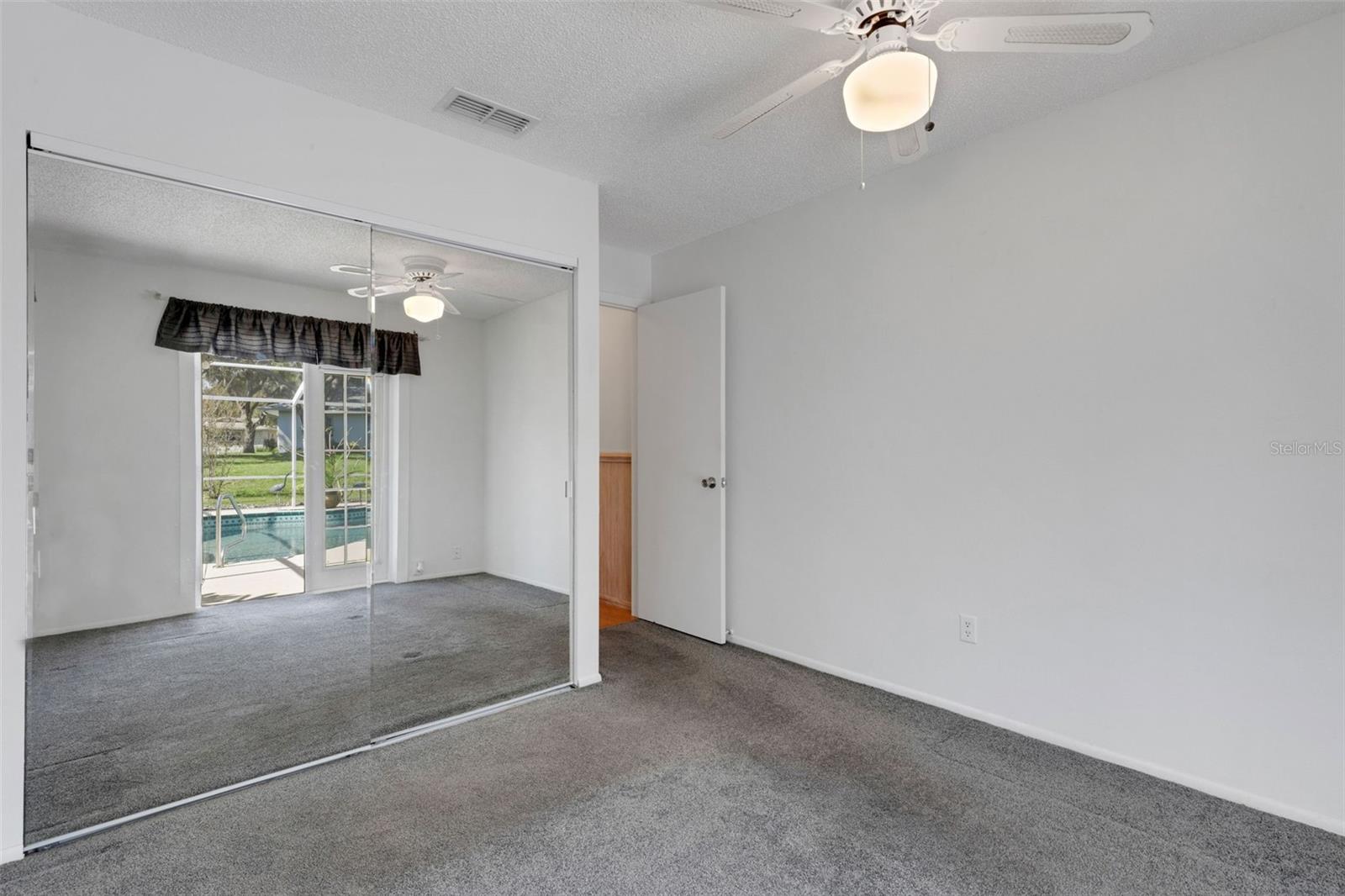 Mirrored closet doors reflect the pool
