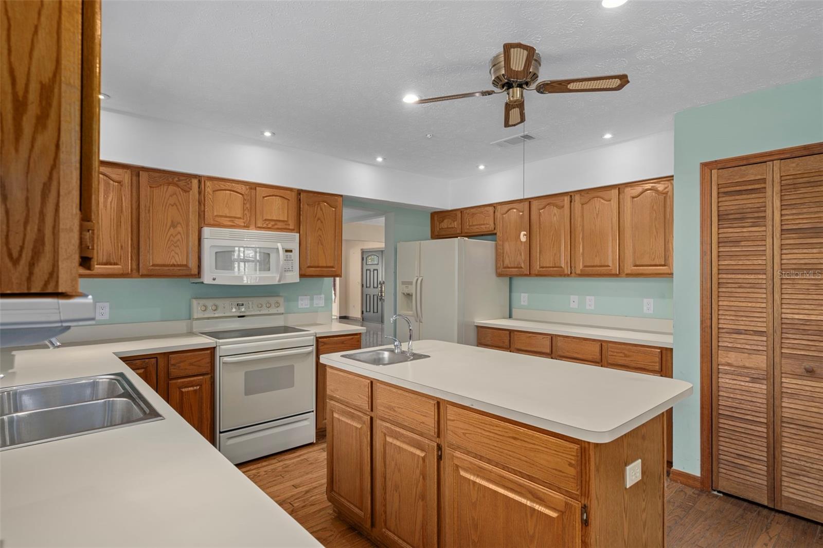 Kitchen with Ample Cabinetry and Hardwood Floors