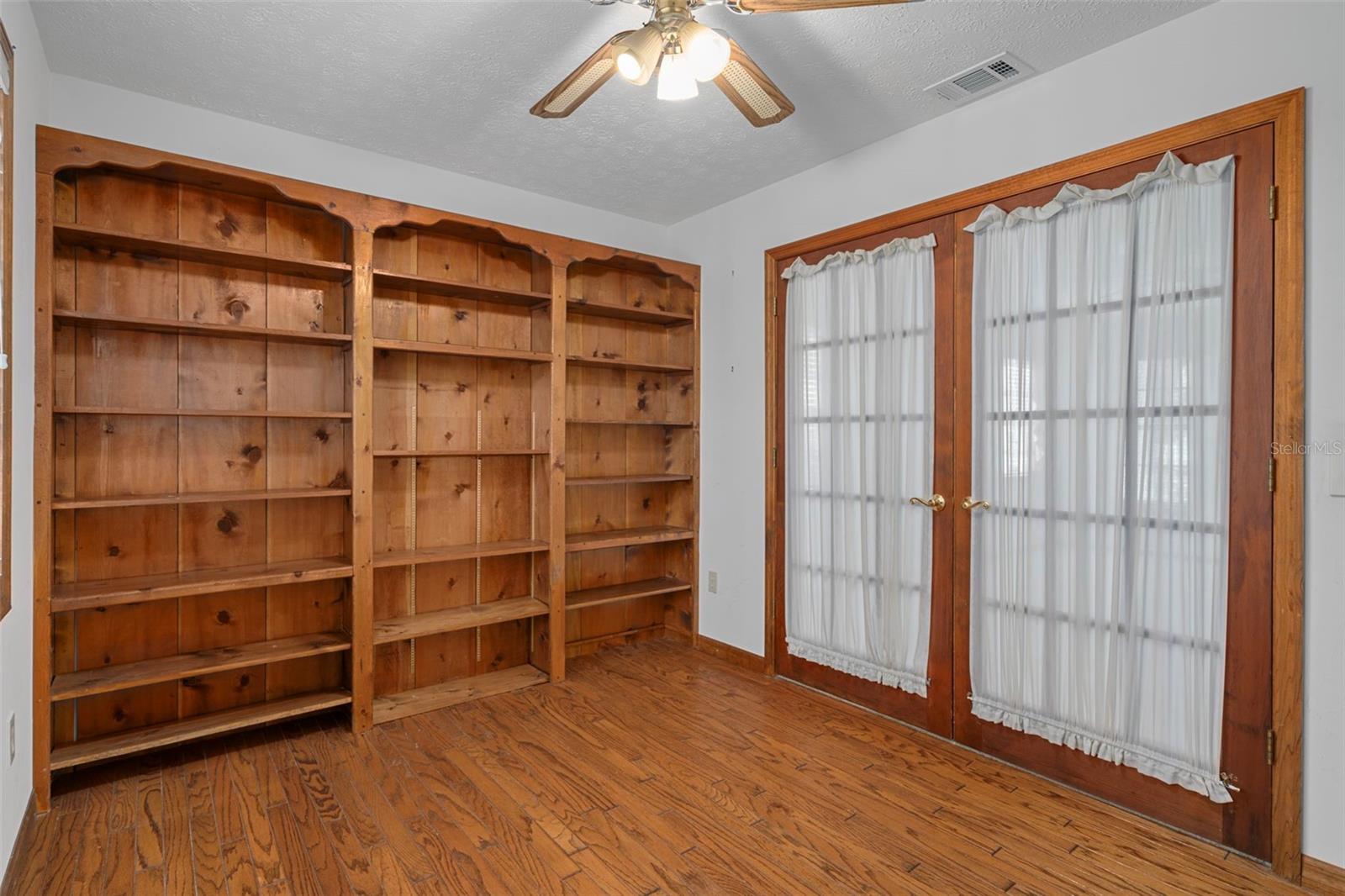 Office/Den/Library with Built-ins, French Doors, and Hardwood Floors