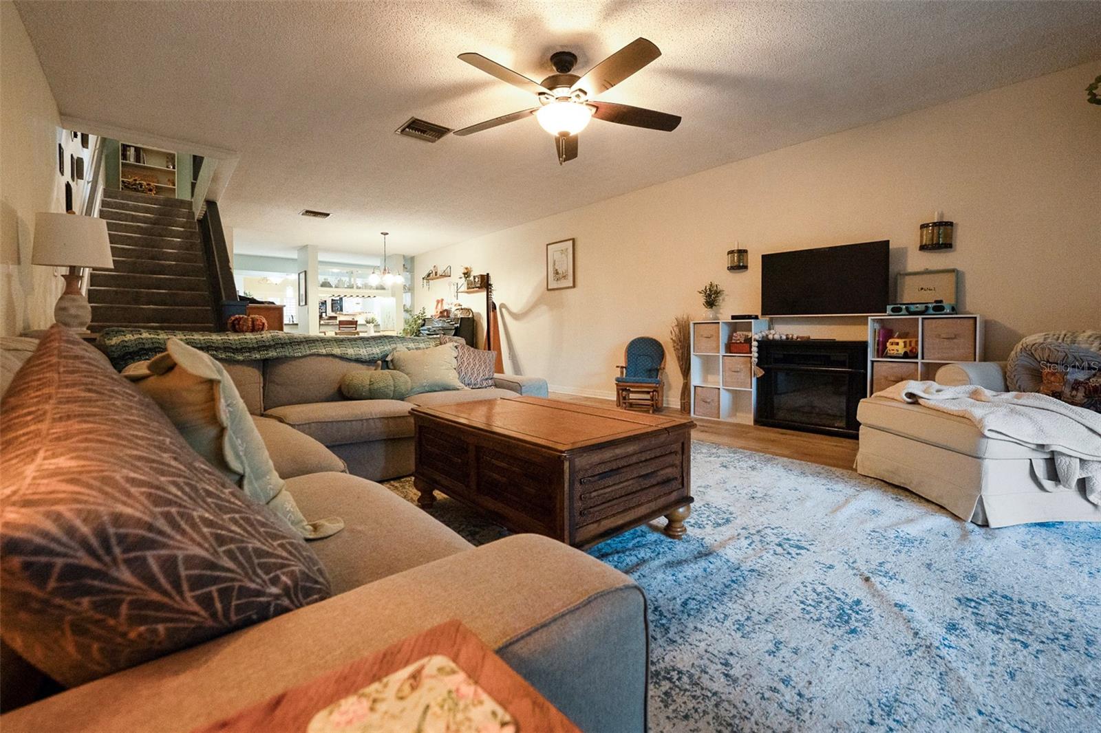 Spacious Living Room with Dining Room and Kitchen views and stairs