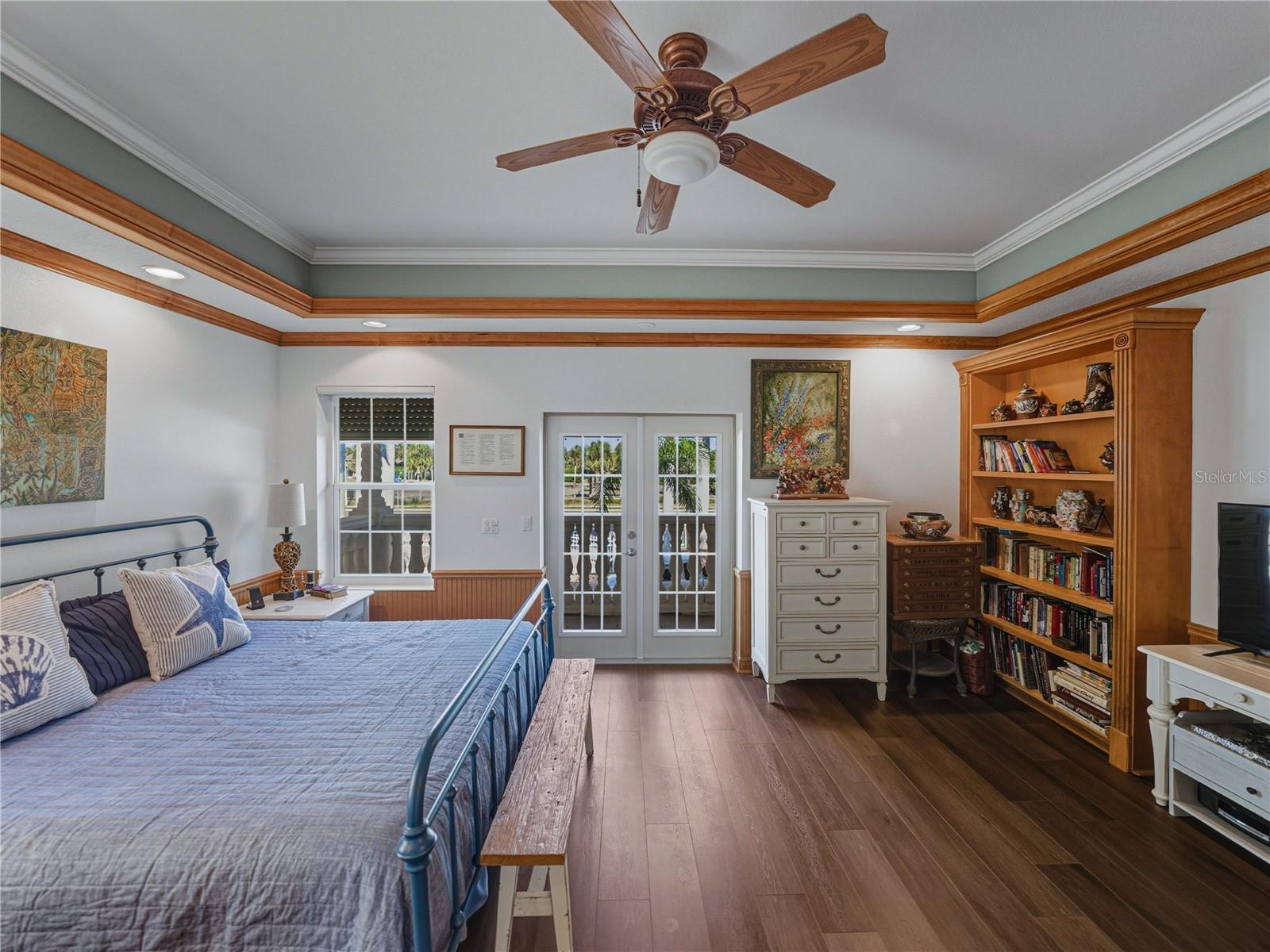 Bedroom 2 on Second floor with tray ceiling and wainscot.