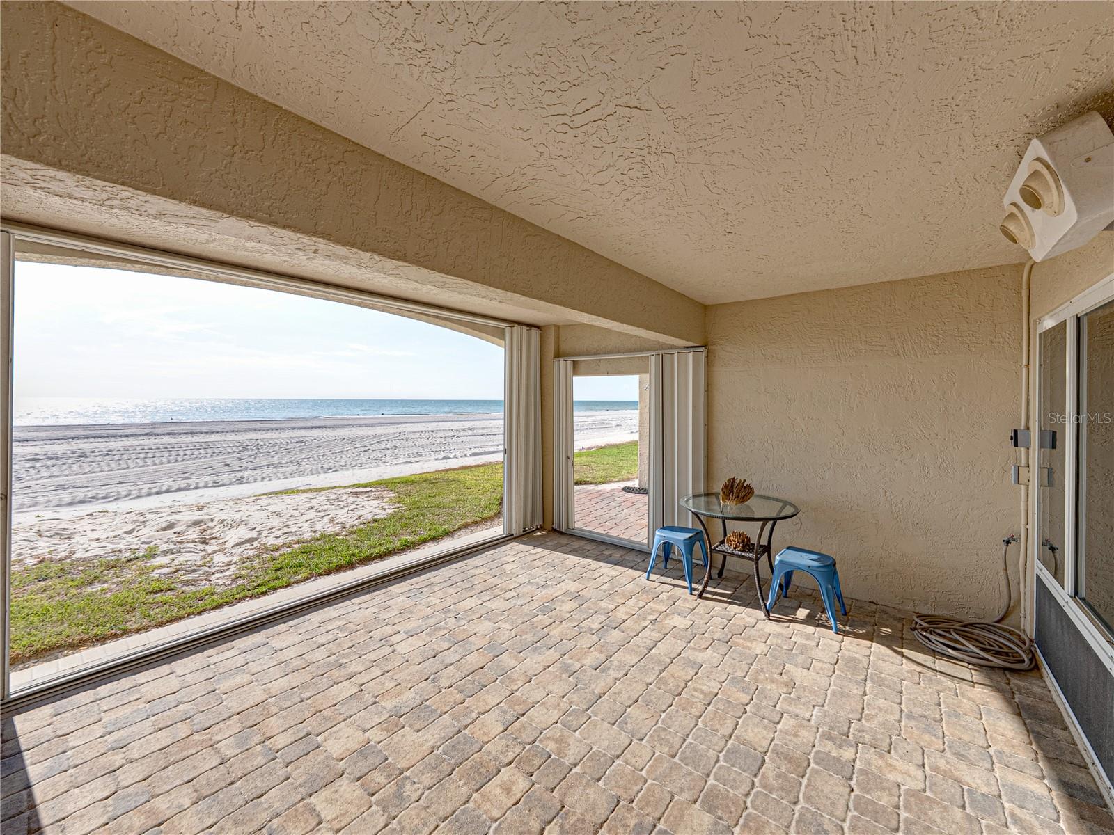 Ground level patio and newly-renourished beach with dunes