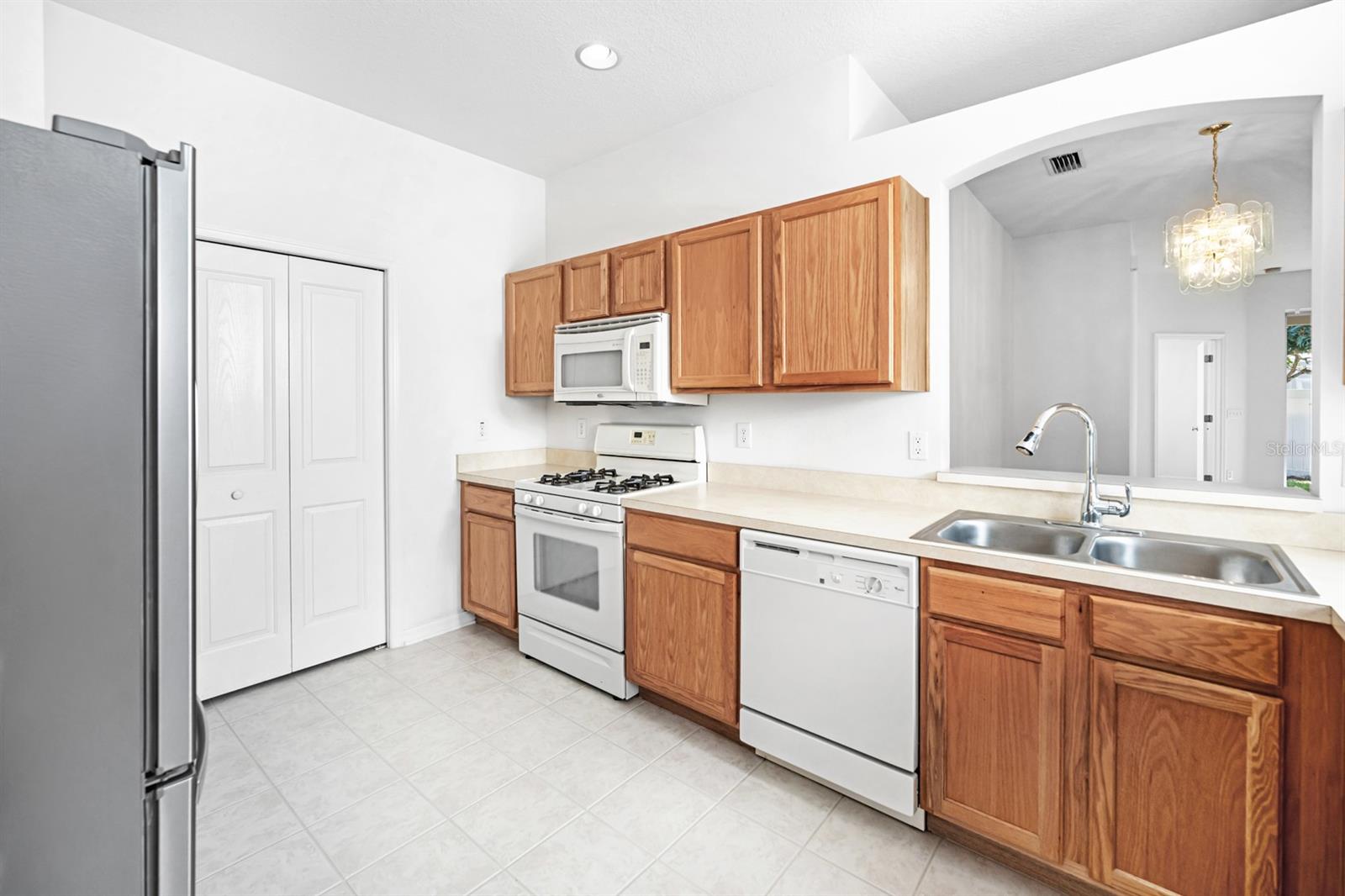 KITCHEN VIEW #3, GAS STOVE AND OPEN AREA ABOVE SINK