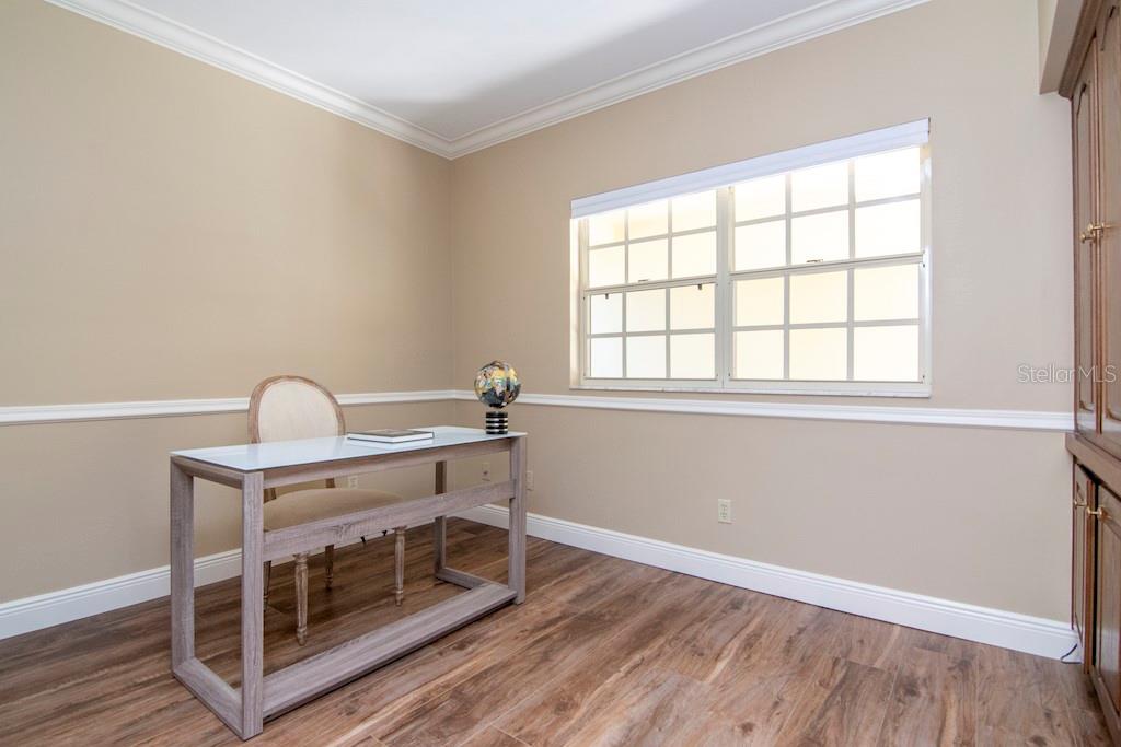 A versatile third bedroom currently configured as a den/study