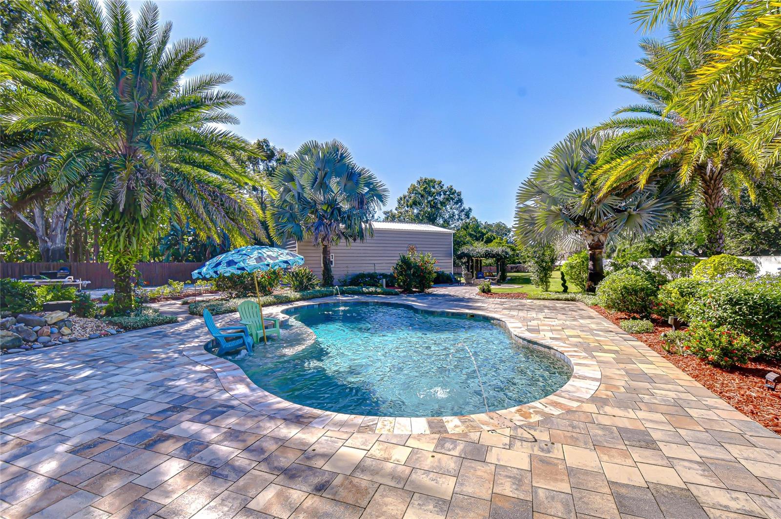 Freeform Heated Pool with in-water Sundeck and Fountain Features