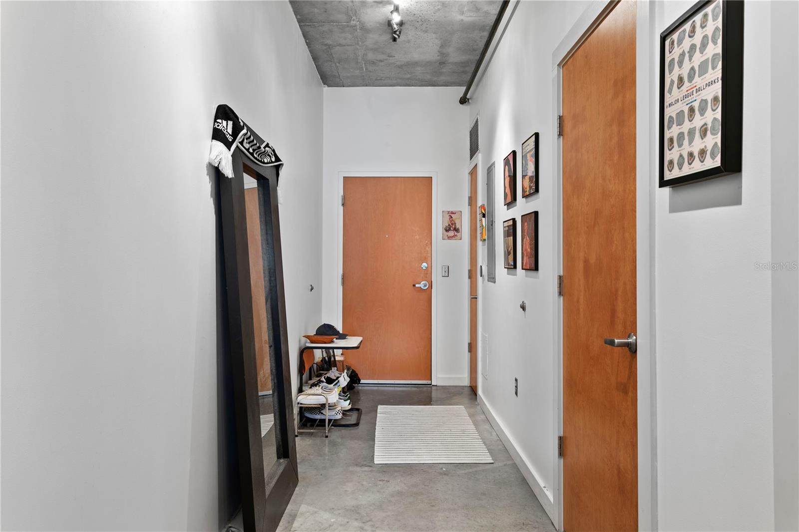 Welcoming hallway entrance features a convenient half bath for guests and an additional storage closet for extra organization