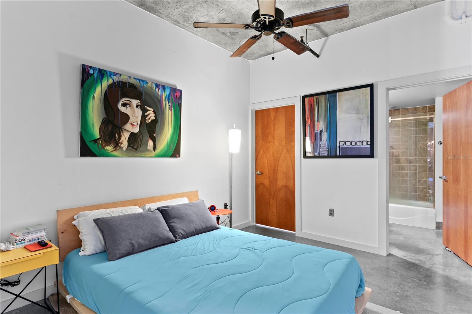 The spacious primary bedroom has direct access to an ensuite bathroom with tiled shower. A cozy yet chic retreat perfect for modern living.