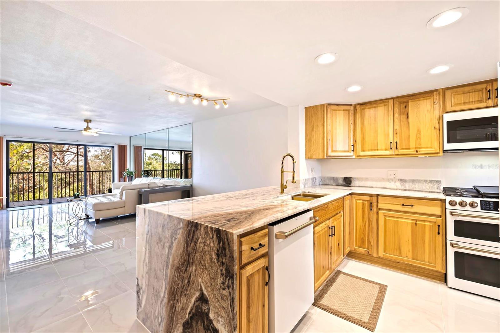 Waterfall granite in the kitchen opened up to the dining and living rooms for a large spacious living area