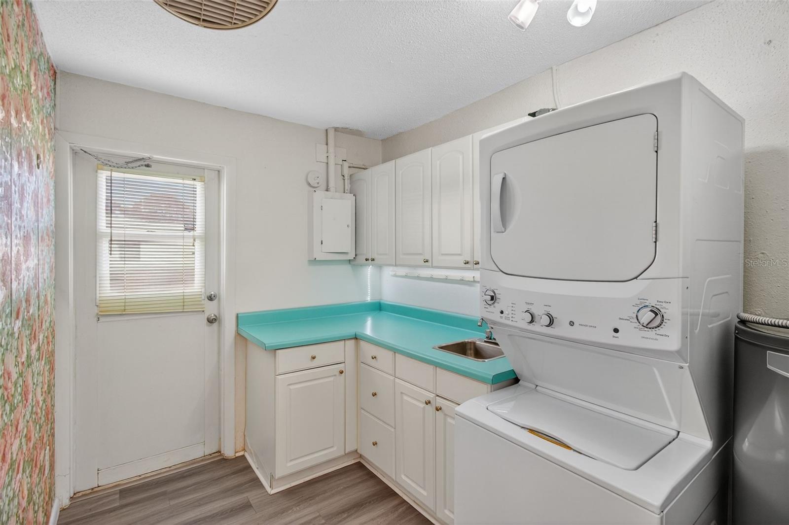 Indoor Laundry Room has cabinets for added storage.