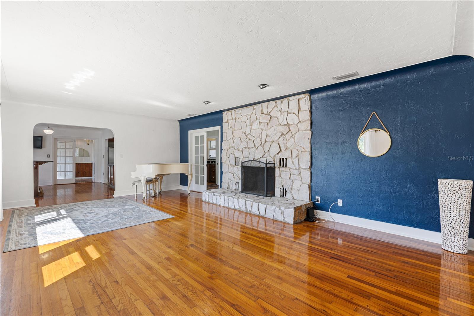 Relax by the woodburing fireplace in the spacious living room.