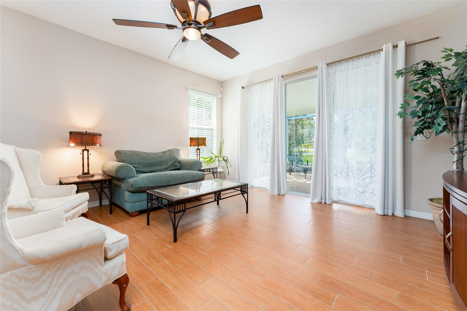living room with sliding glass doors leading out to lanai