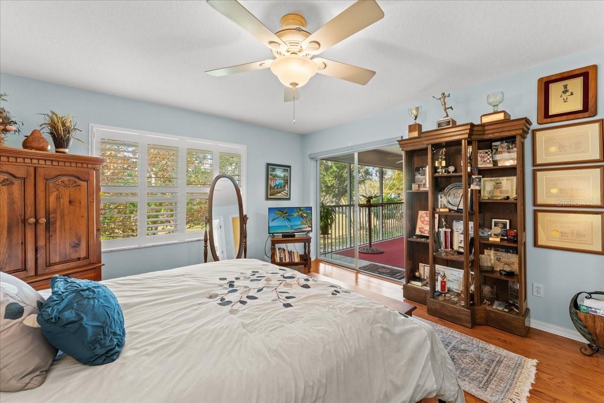 Primary Suite with view toward the patio access. LOTS of natural light