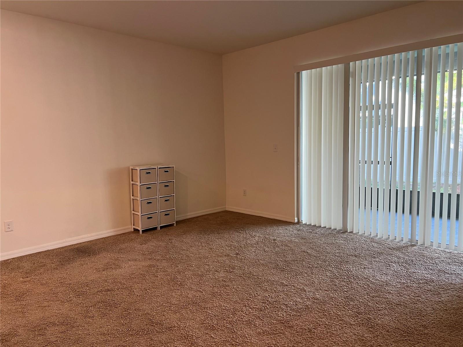 Living Room with sliding door to enclosed lanai.