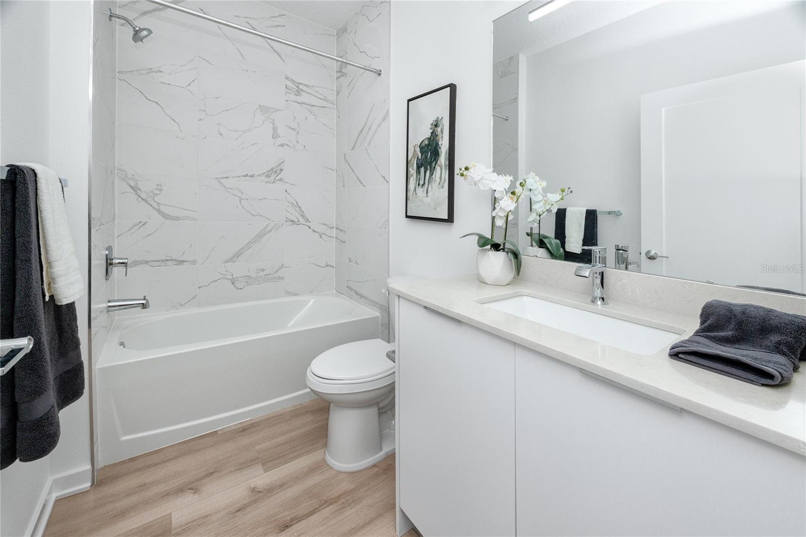 Guest bathroom downstairs has tub/shower combo