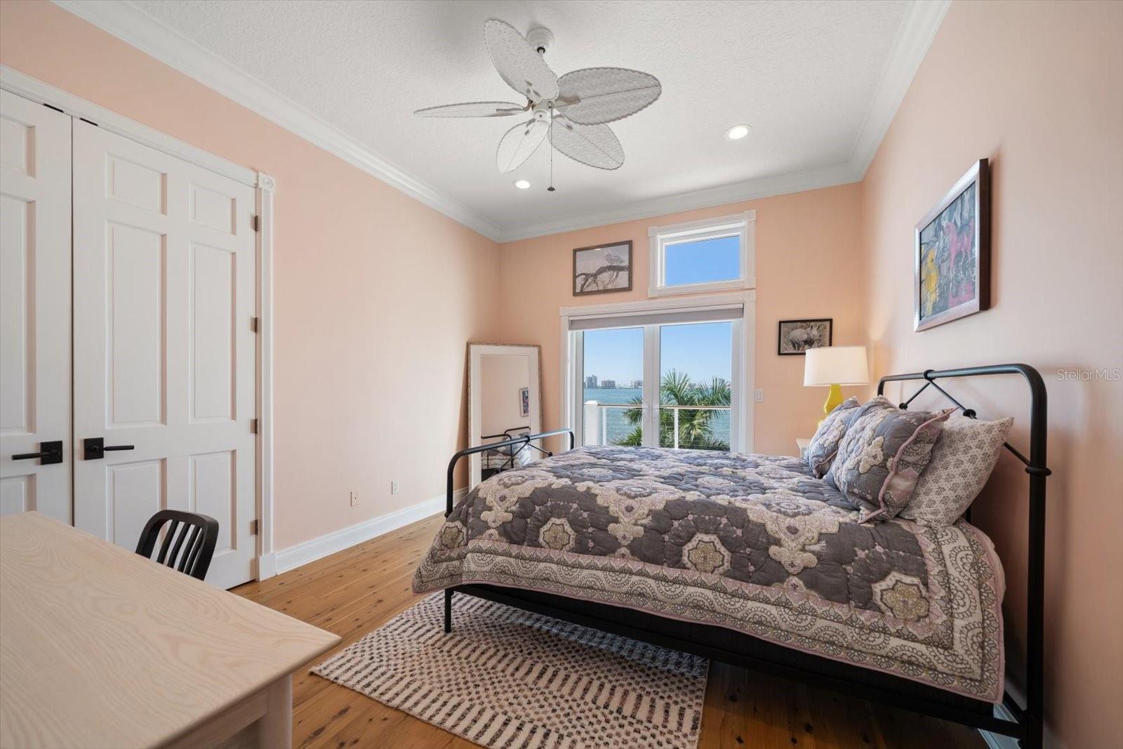 3rd bedroom with walk in closet and french doors to the balcony