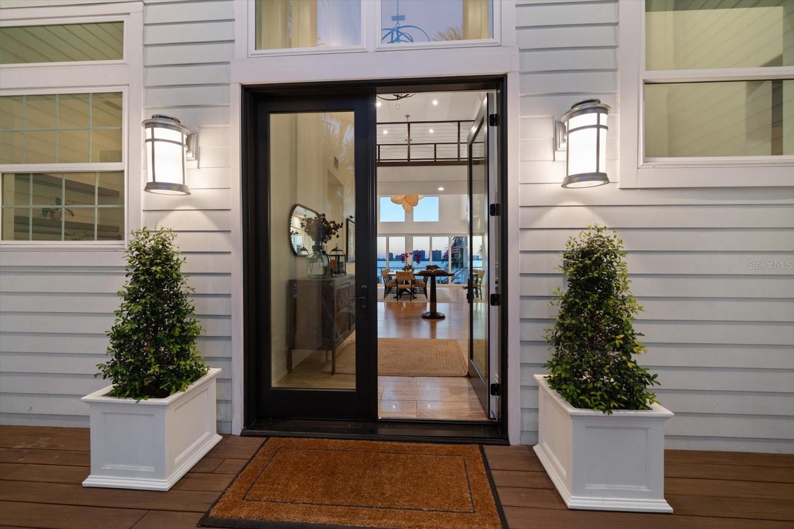 Enter through the double glass door to the grand foyer and immediately enjoy water views