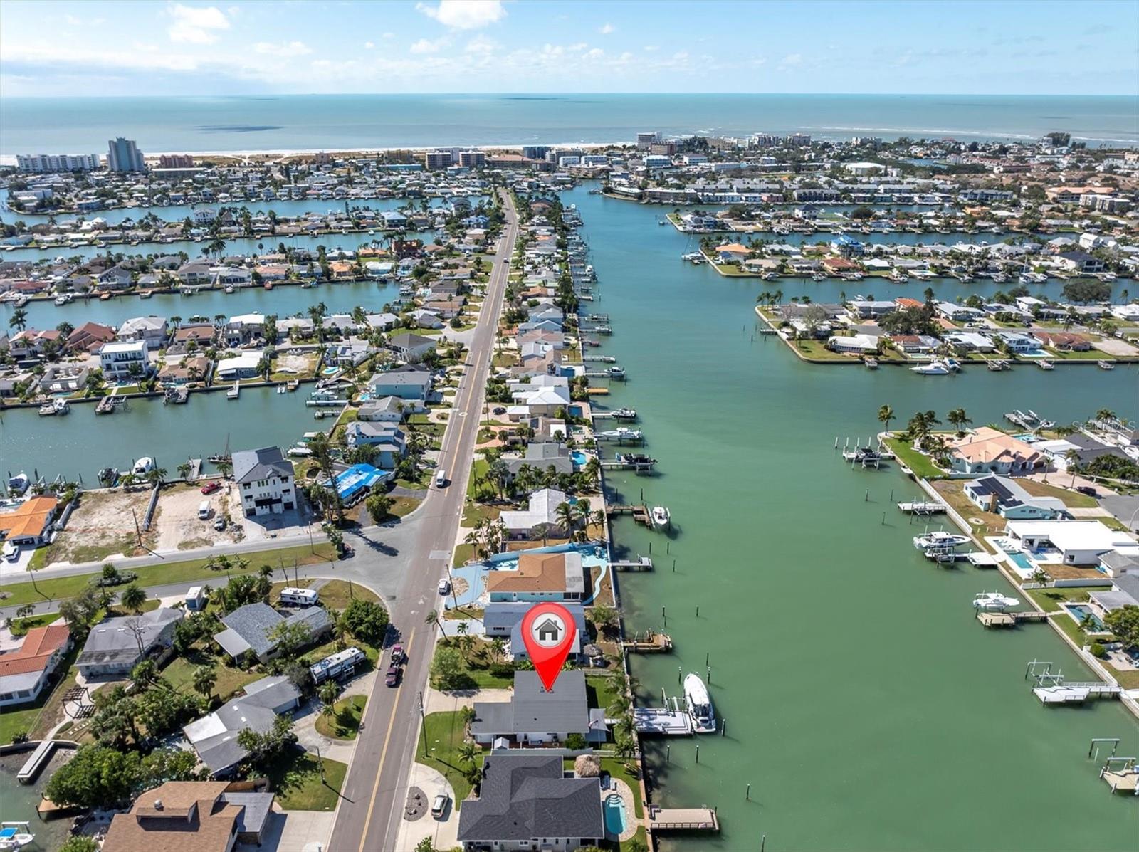 Stunning waterfront aerial view showing the property, Blind Pass channel, and Gulf; providing deep-water access to open waters.