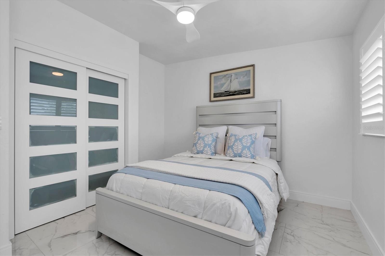 The second bedroom also features sliding closet doors.