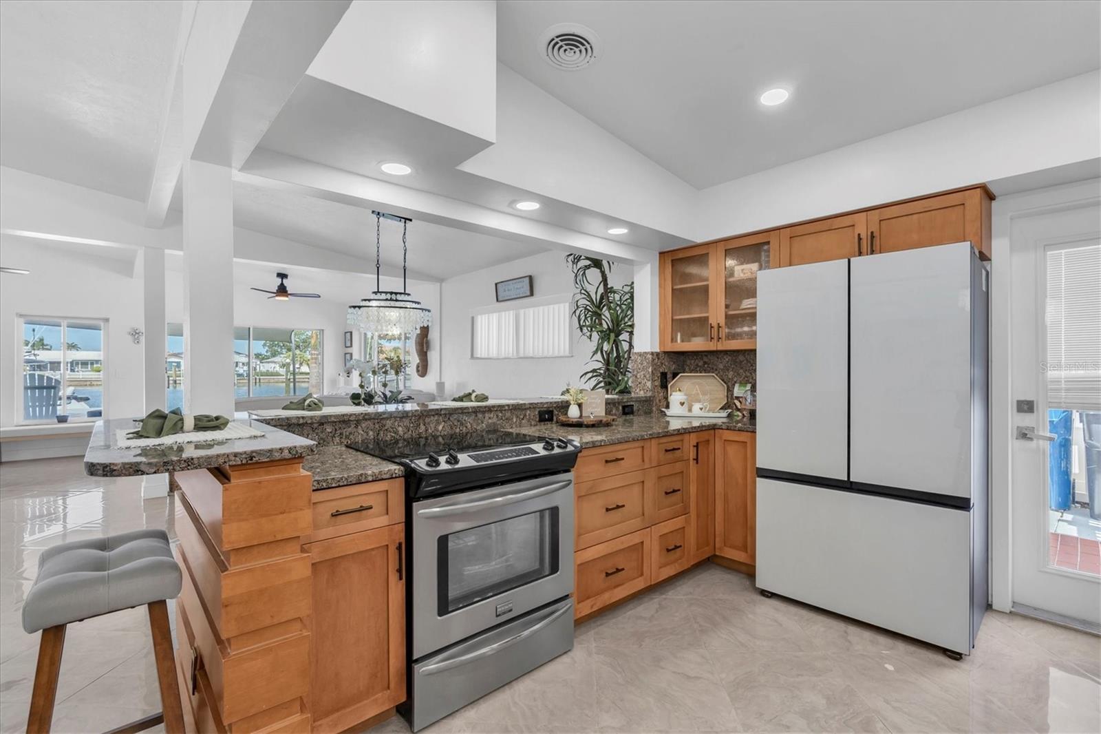 From the kitchen, enjoy stunning water views while the snack bar accommodates friends and family. The open floor plan allows you to cook, entertain, and connect—embracing the very best of Florida coastal living.
