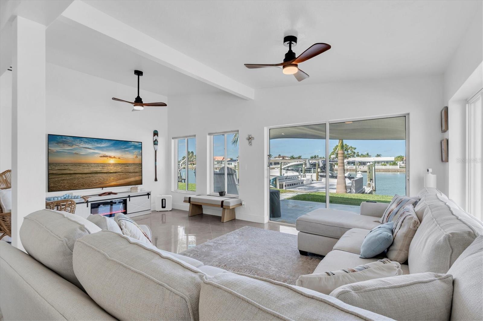 Relax in the living room while enjoying breathtaking water views and lush tropical landscaping. Step outside to entertain on the spacious patio or expansive dock.