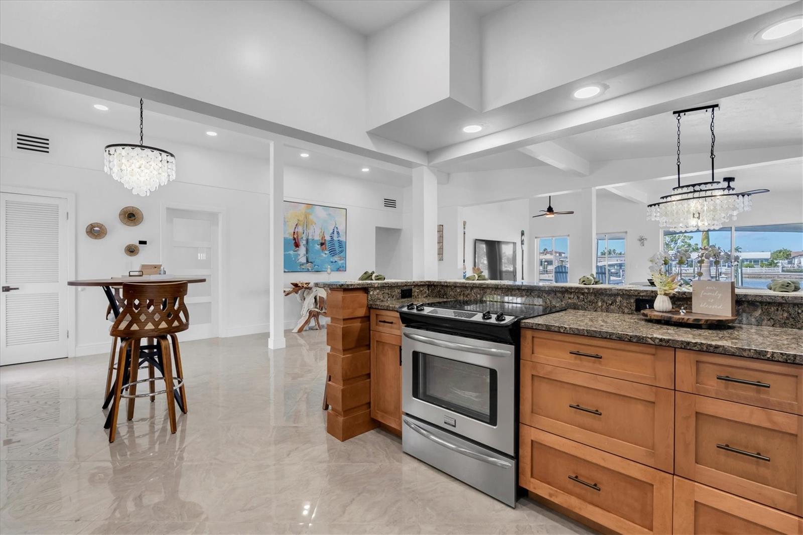 Open-design kitchen with granite countertops and a spacious snack bar, perfect for chefs and entertaining