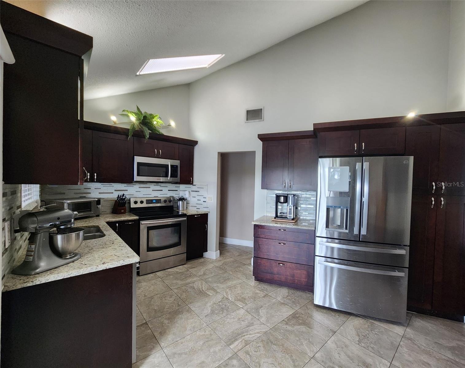 Chef's Dream Kitchen with stainless appliances and stone counters