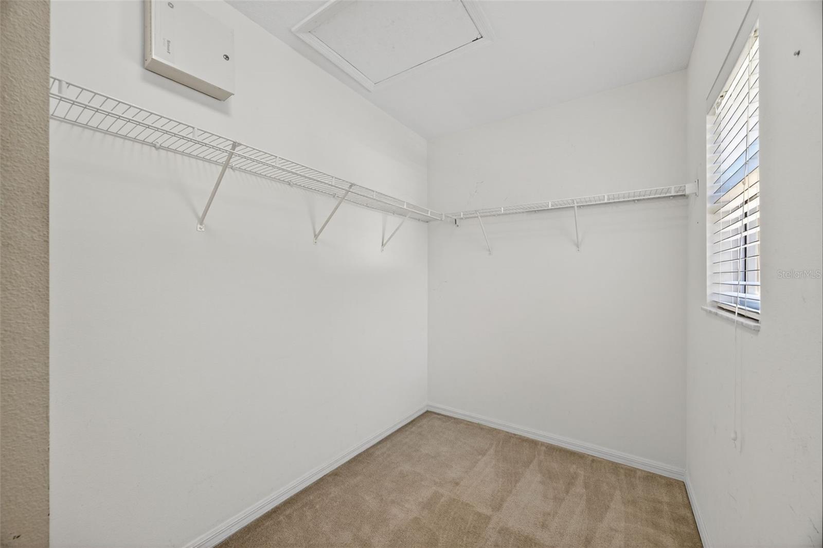 Partial view of primary bedroom walk-in closet