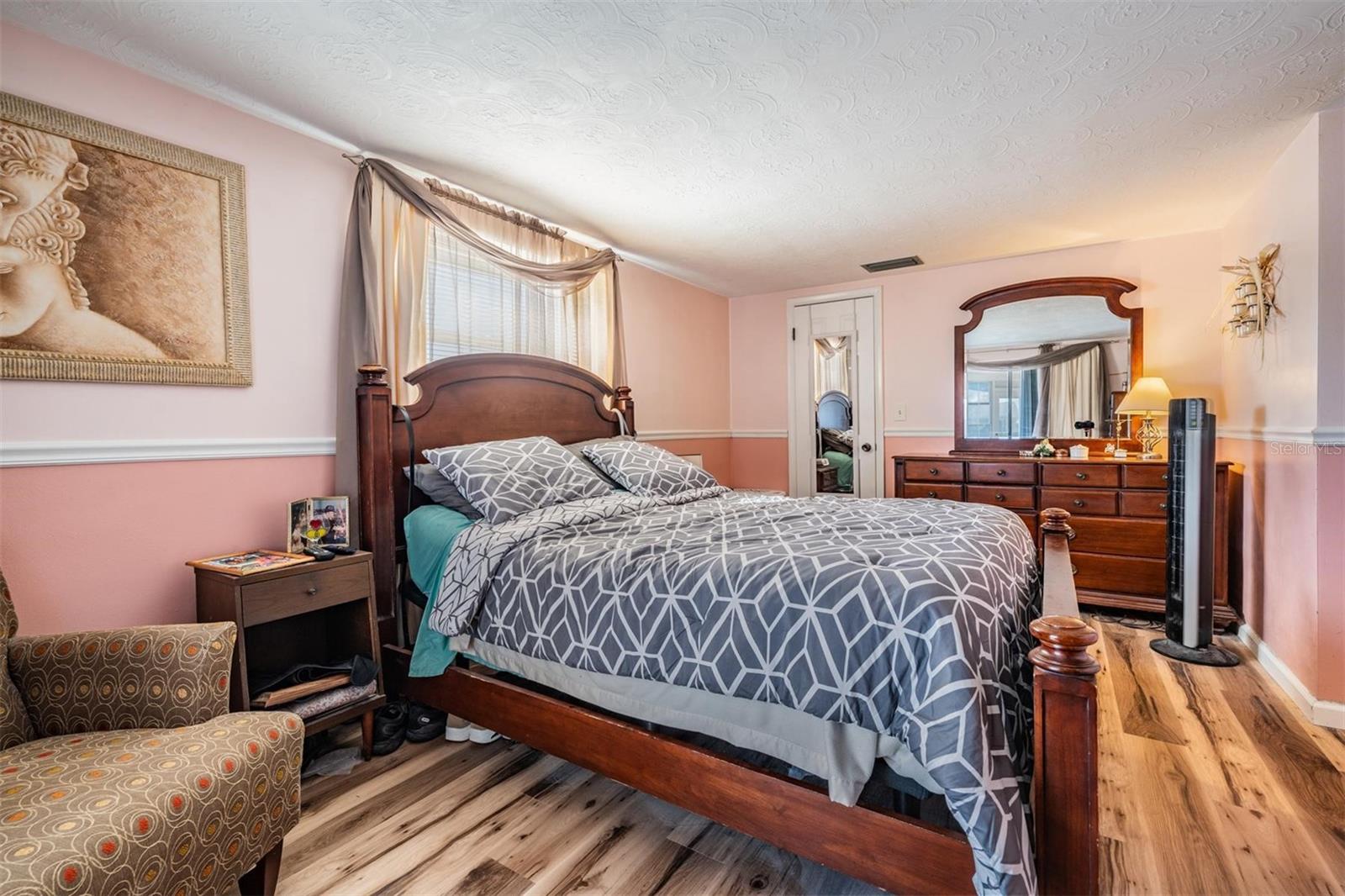 Primary Bedroom with slider doors and ensuite bathroom.