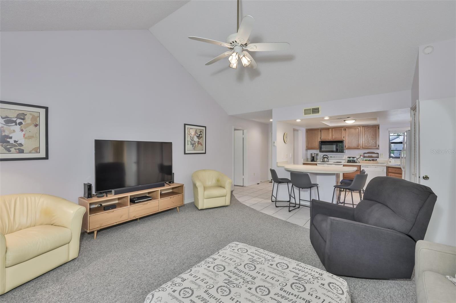 3.0 •_Open, airy living area with soaring ceilings and natural light throughout